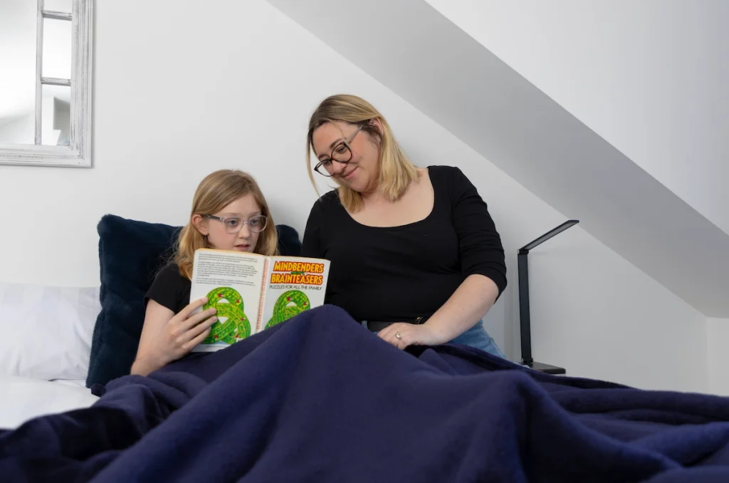 FosteringNorthSomerset_foster-care-reading-caring-girl