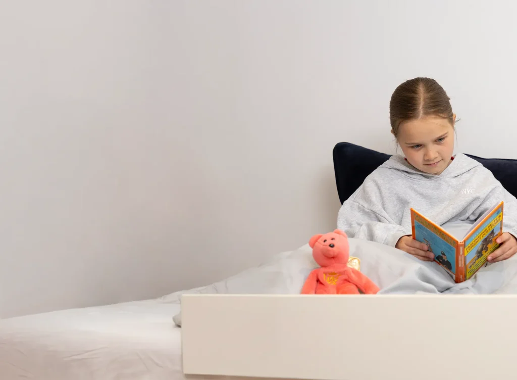 Girl-Reading-Book-in-Bed-Fostering-North-Somerset-HQ-img